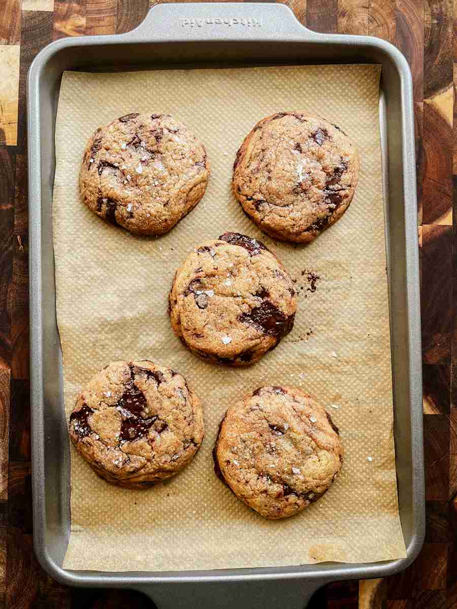 Brown butter sourdough chocolate chip cookies with gooey chocolate and flaky sea salt on top.