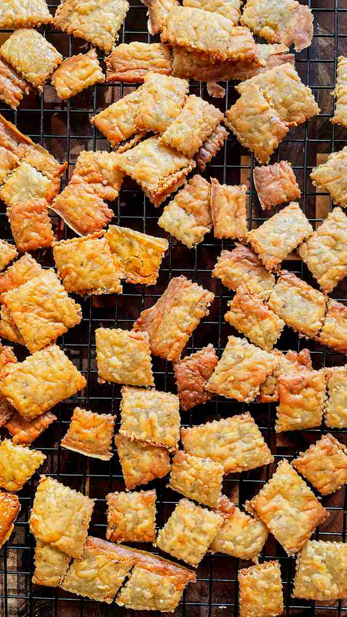 Close up of a sourdough cheese cracker showing its crisp, golden texture.