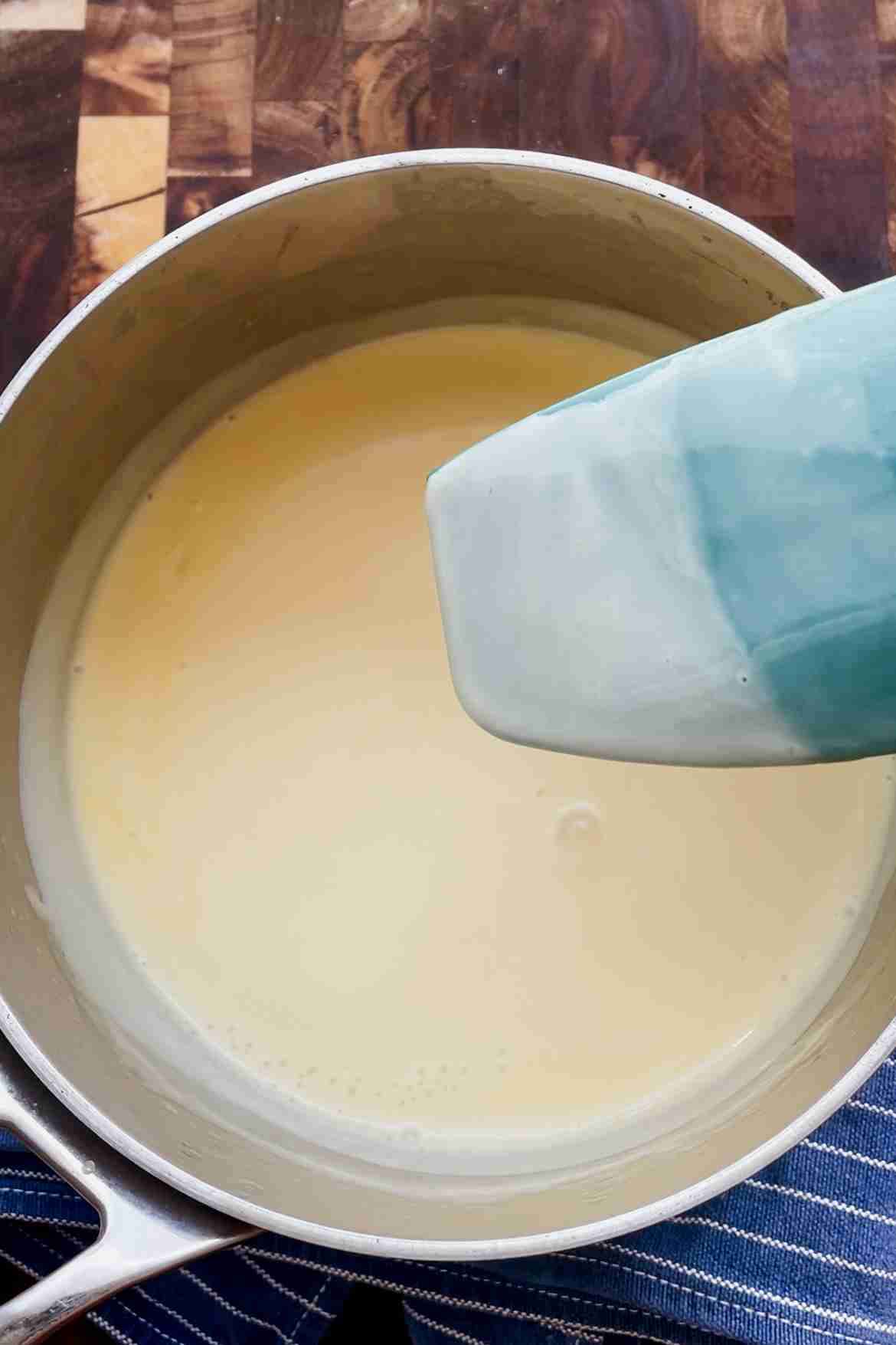 Thickened vanilla custard coating the back of a spoon