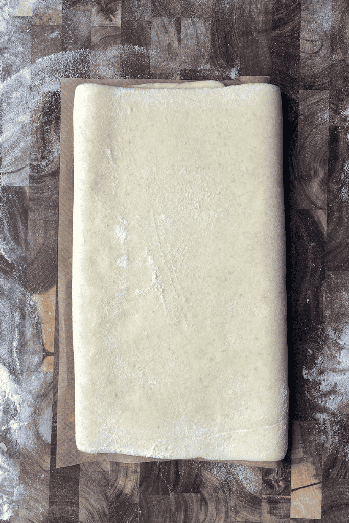 Wrapped puff pastry dough resting in the fridge between folds