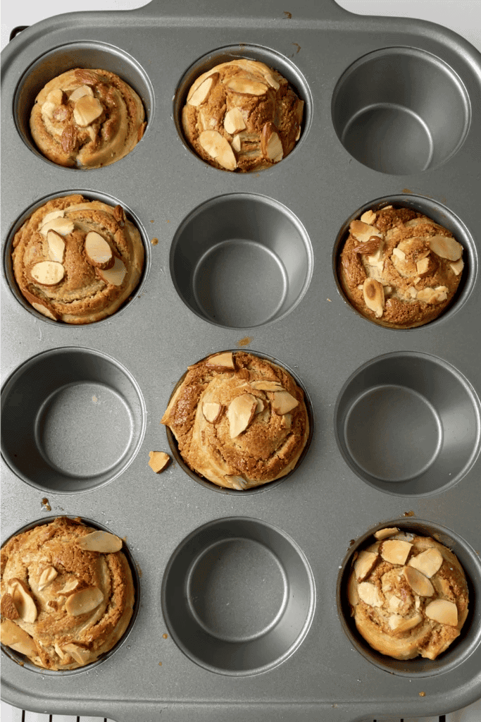 baked sourdough cruffins placed in a greased muffin tin