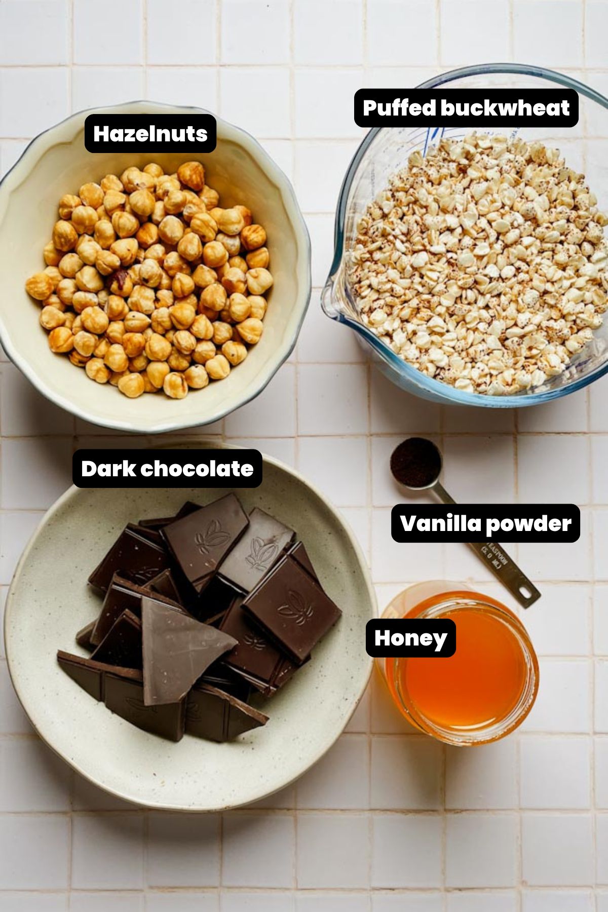 ingredients for chocolate crunch bars including dark chocolate, hazelnut butter, honey, and puffed buckwheat