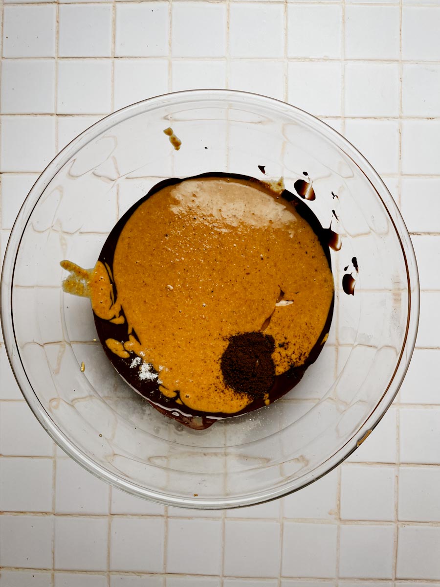 mixing melted chocolate with hazelnut butter and honey for chocolate crunch bars
