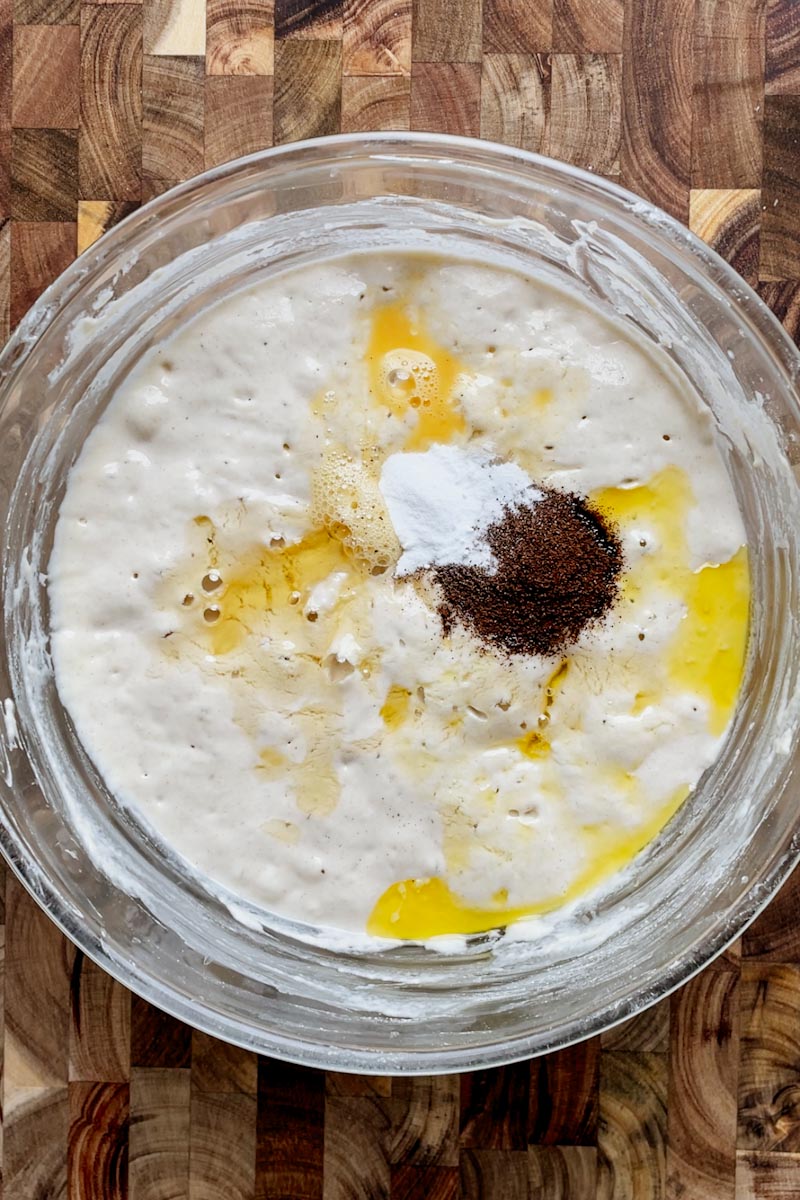 adding eggs and ingredients to sourdough pancake batter
