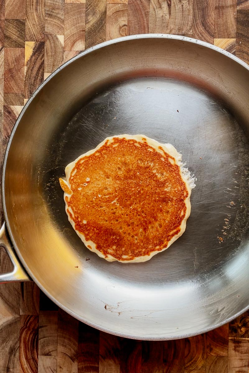 golden brown fluffy sourdough pancake after flipping