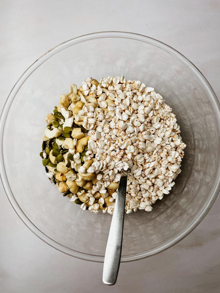 Mixing nuts seeds and puffed buckwheat with honey for nut bars