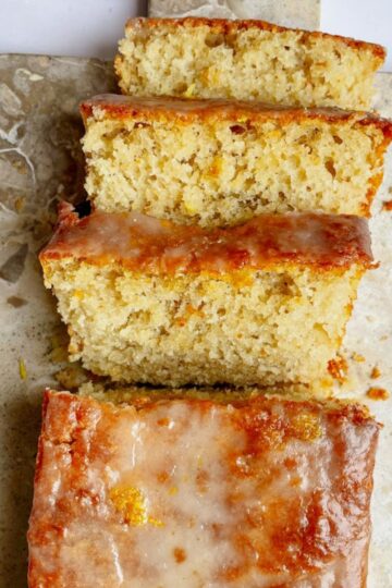 Sliced sourdough lemon loaf with lemon glaze drizzled on top