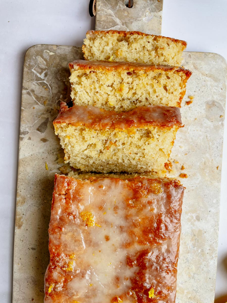 Sliced sourdough lemon loaf with lemon glaze drizzled on top