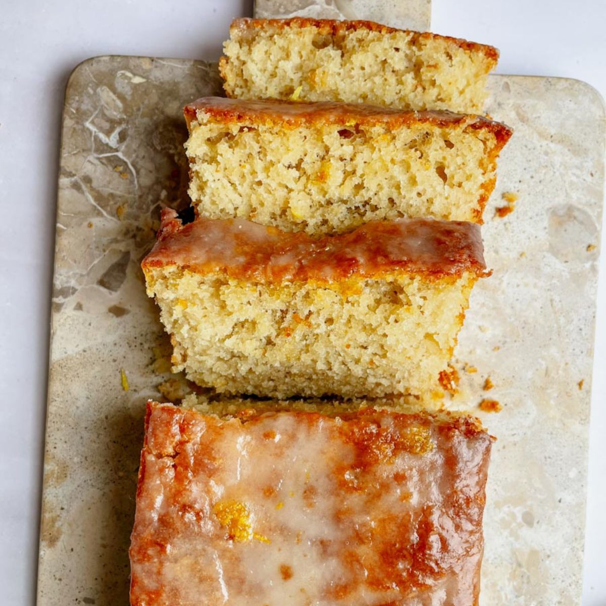 Sliced sourdough lemon loaf with lemon glaze drizzled on top