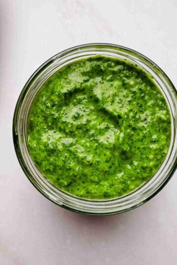 pesto sauce without pine nuts made with cashews in a bowl with fresh basil