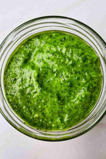 pesto sauce without pine nuts made with cashews in a bowl with fresh basil