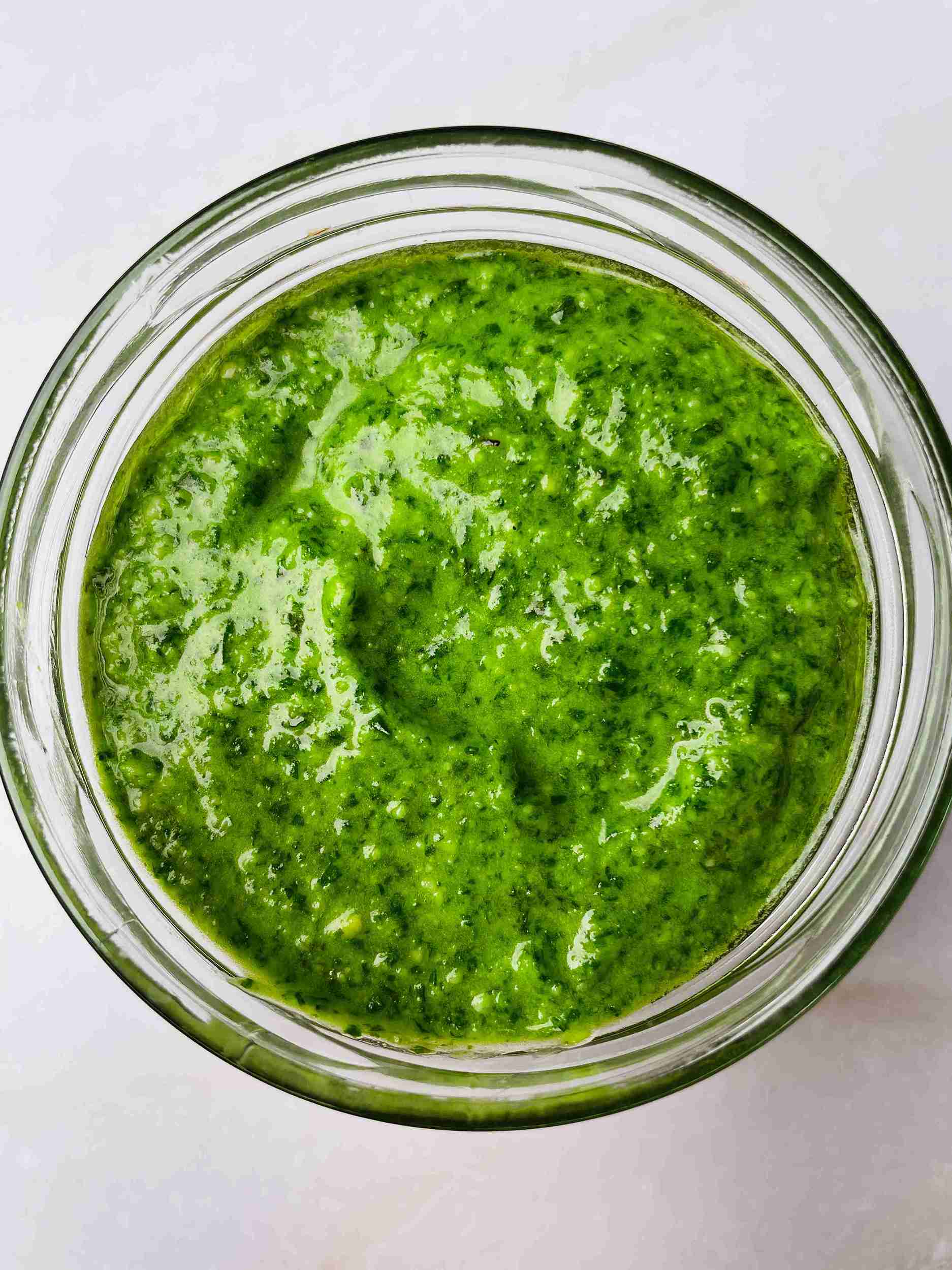 pesto sauce without pine nuts made with cashews in a bowl with fresh basil