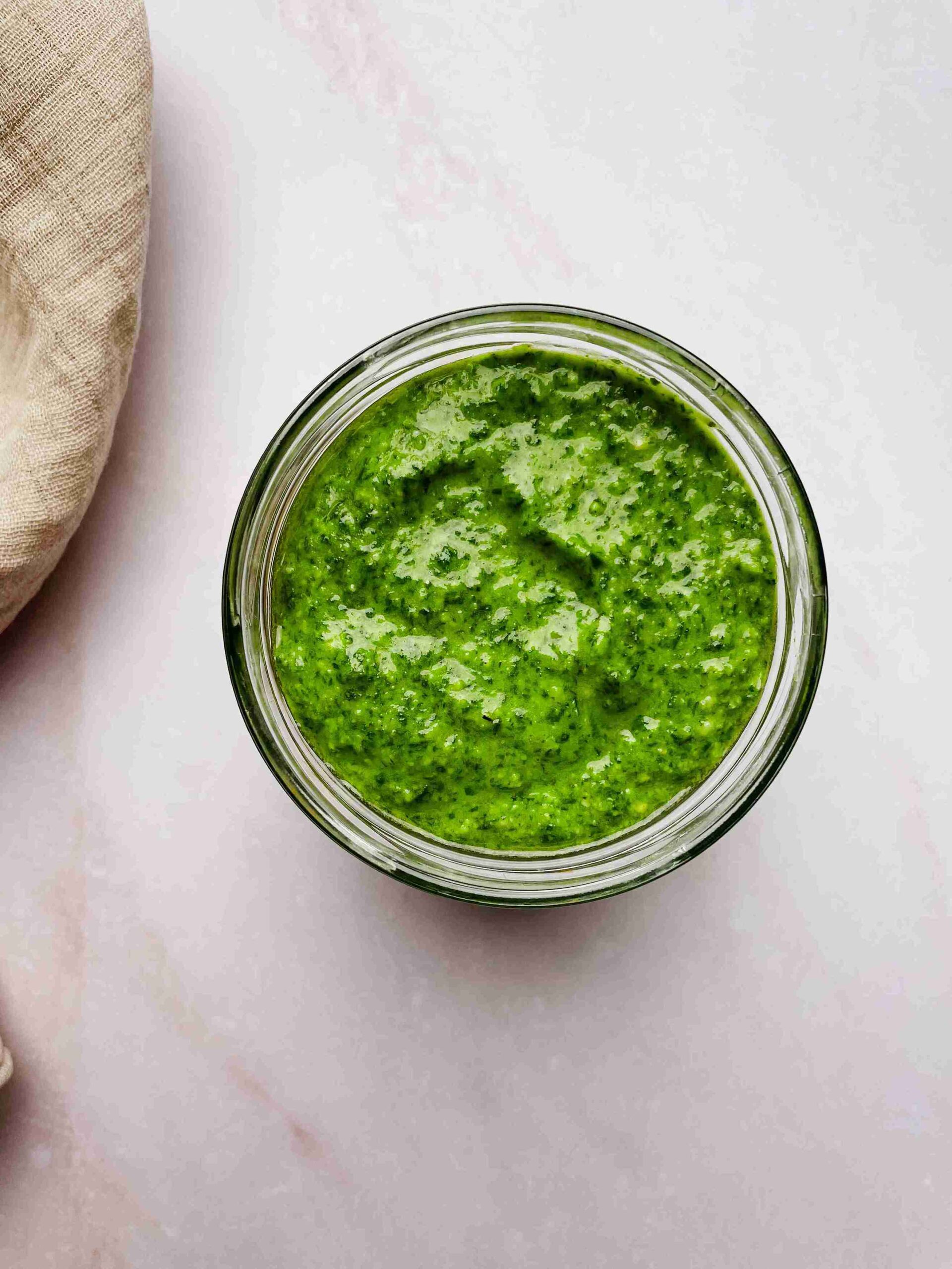 pesto sauce without pine nuts made with cashews in a bowl with fresh basil