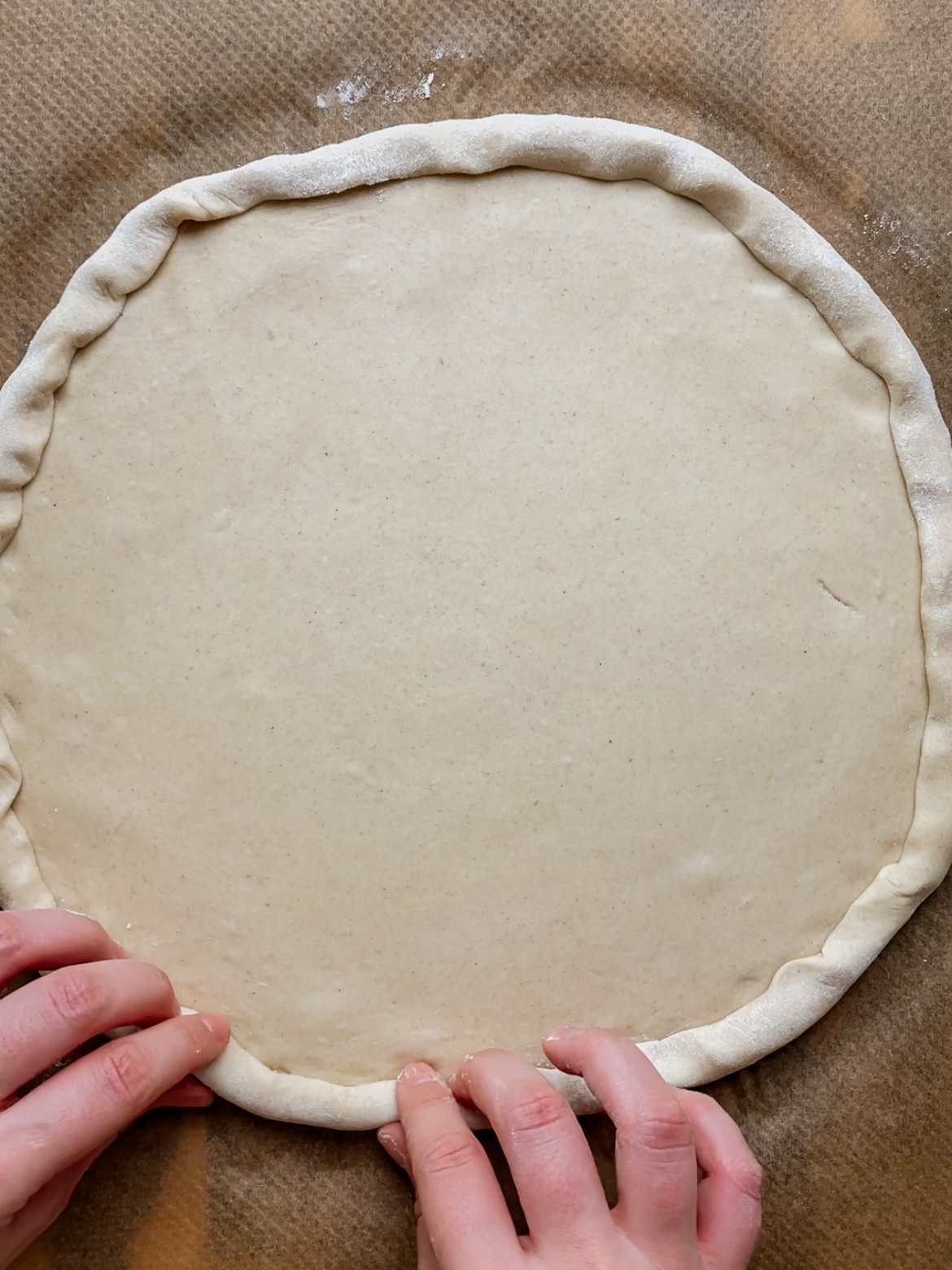 shaping sourdough pizza dough edges into crust