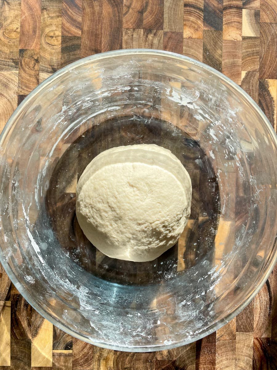 sourdough pizza dough resting in bowl