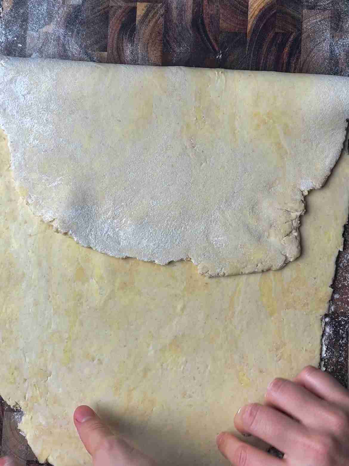 First step of book fold for sourdough puff pastry, one edge folded to center