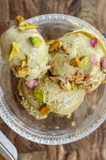 Bowl of creamy homemade pistachio ice cream topped with chopped pistachios.