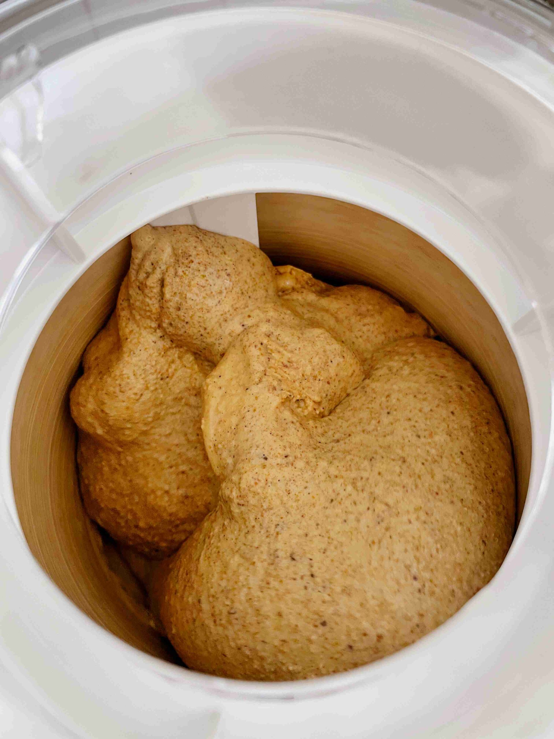 Pistachio ice cream churning to a soft, creamy consistency in an ice cream maker.
