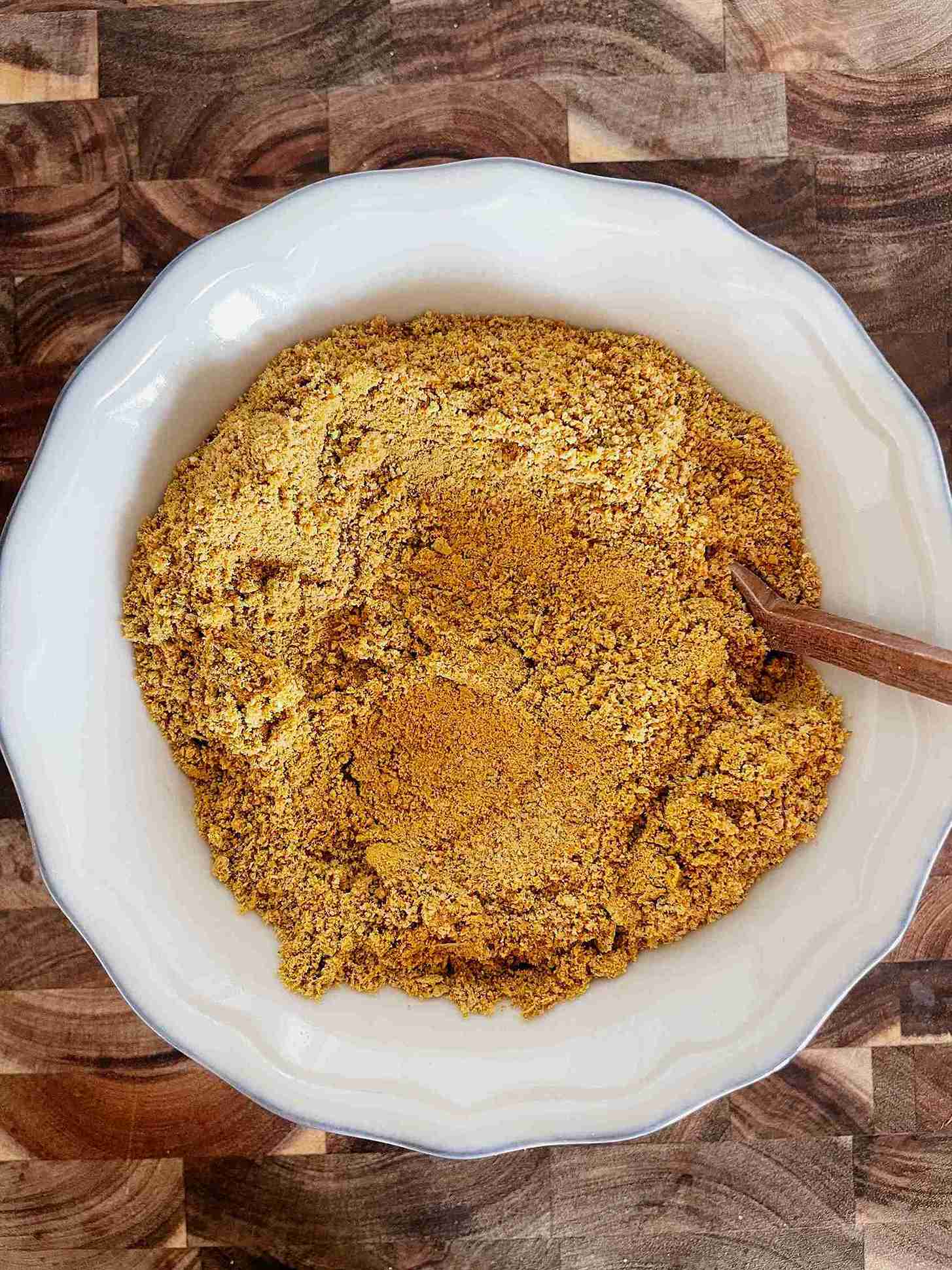 Finely ground pistachios and sugar in a bowl for pistachio ice cream.