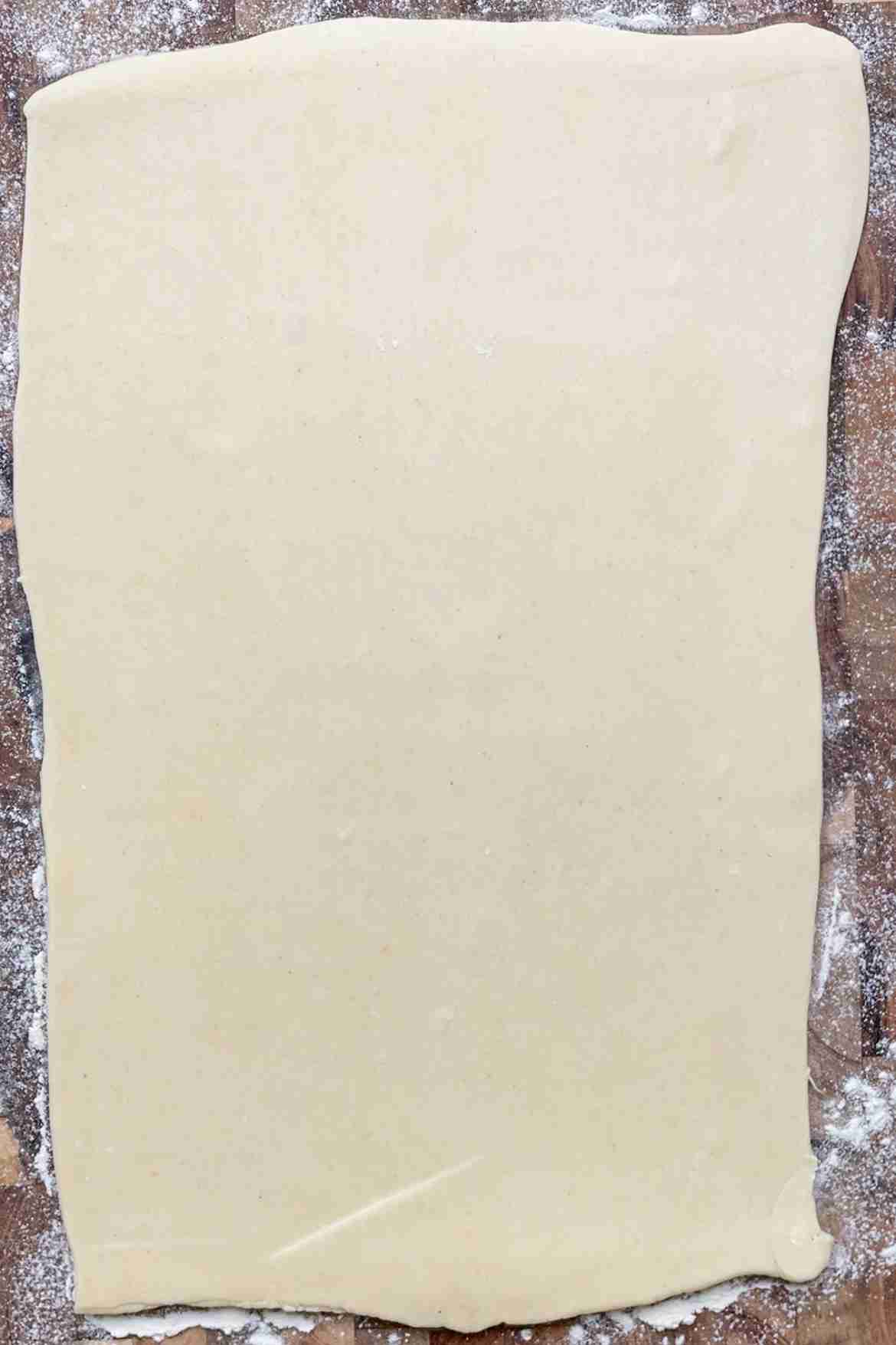 Puff pastry rolled into a long rectangle on a lightly floured surface