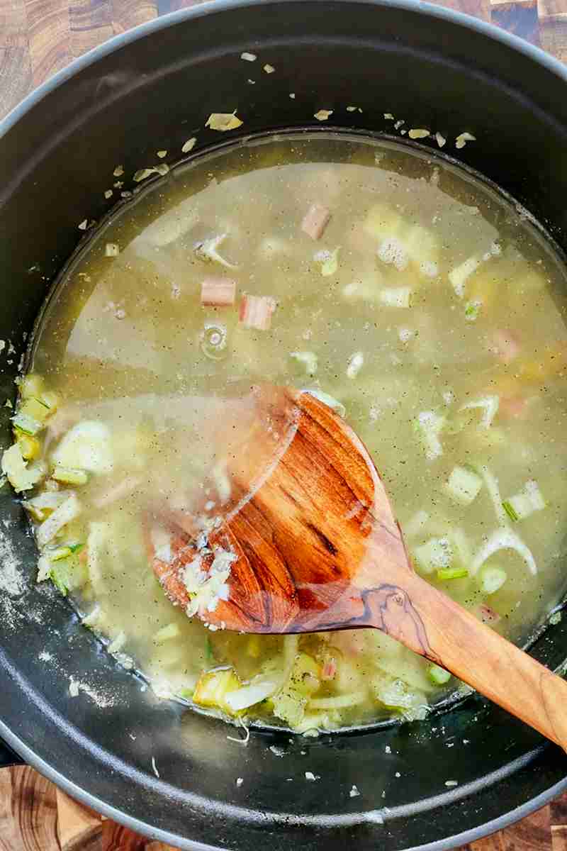 Bone broth and water simmering with fennel and swiss chard stems.